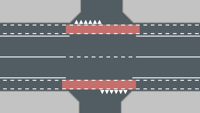 Fietspad dat doorloopt over een kruispunt op de rijbaan